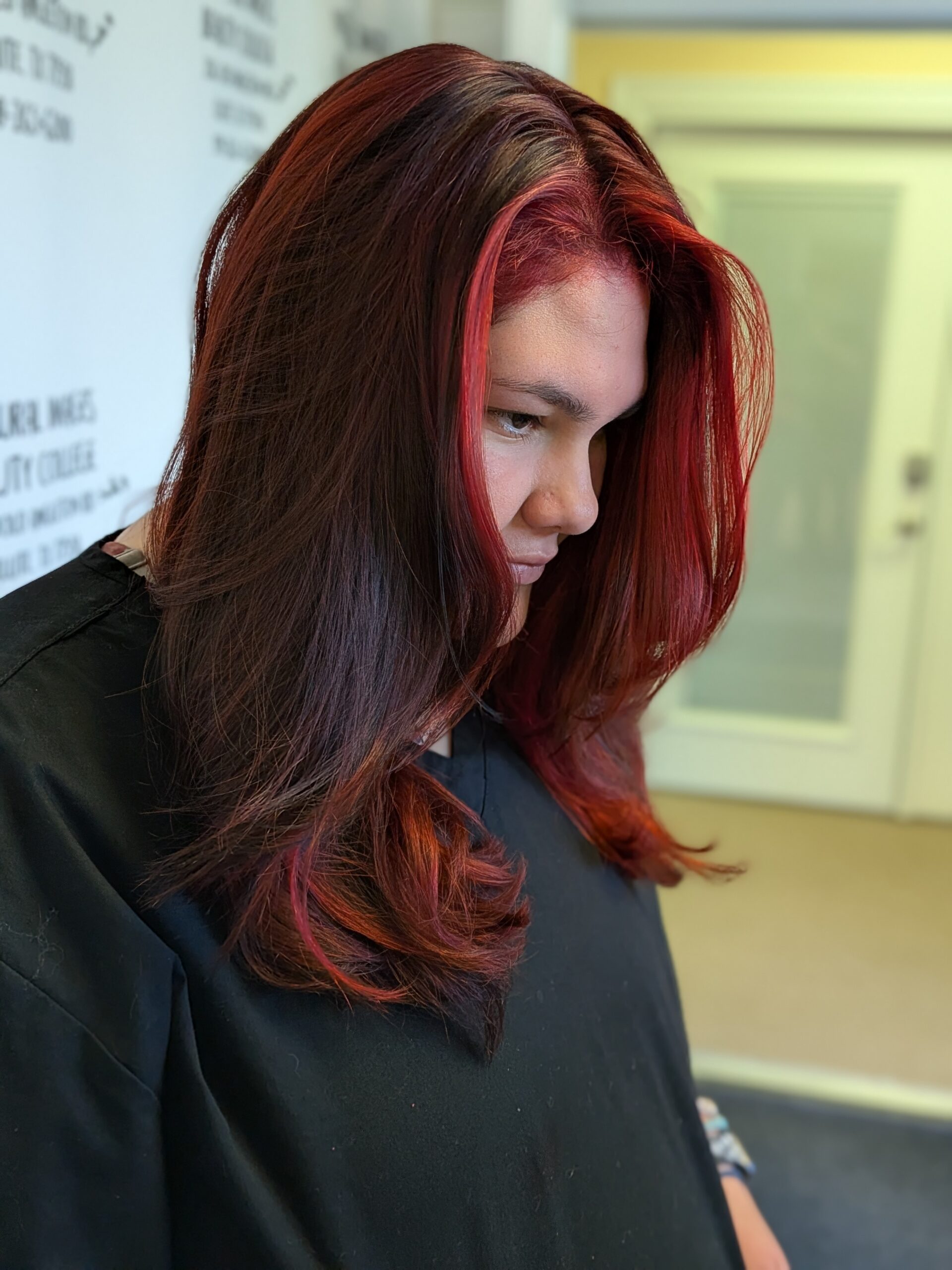 Hair cut, long layers with a multi color dark and vivid red hand painted balayage.in clute texas